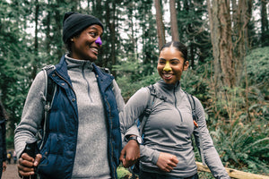 Two females hiking outdoors while wearing Nöz eco friendly sunscreen